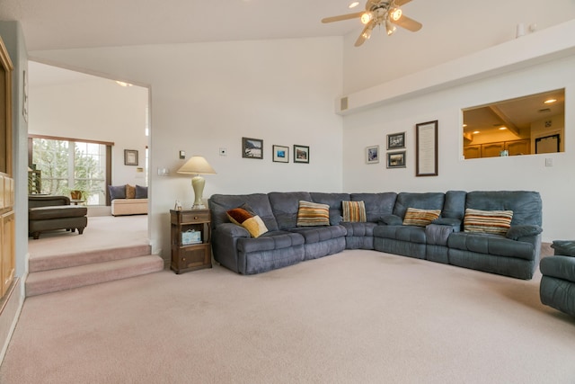 living room featuring carpet, a high ceiling, and ceiling fan