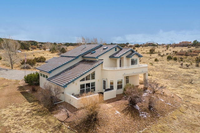 view of front of house with stucco siding and a tile roof