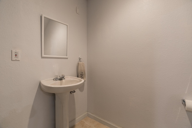 bathroom featuring tile patterned flooring and baseboards