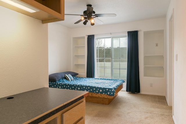 bedroom featuring a ceiling fan, baseboards, and light carpet