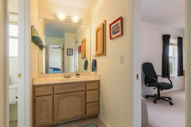 bathroom with tile patterned flooring, vanity, and baseboards