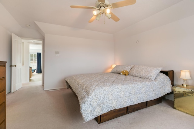 bedroom featuring a ceiling fan, light colored carpet, and baseboards