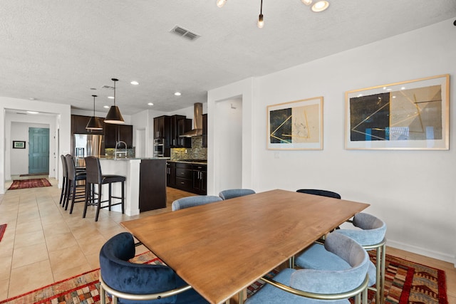 dining room featuring visible vents, a textured ceiling, recessed lighting, light tile patterned flooring, and baseboards