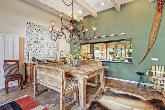 7 Calle Cholla, Placitas, NM 87043 - dining area with brick floors, a chandelier, beamed ceiling, and a towering ceiling