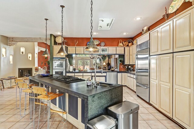 7 Calle Cholla, Placitas, NM 87043 - kitchen featuring dark countertops, light tile patterned floors, appliances with stainless steel finishes, a breakfast bar, and recessed lighting