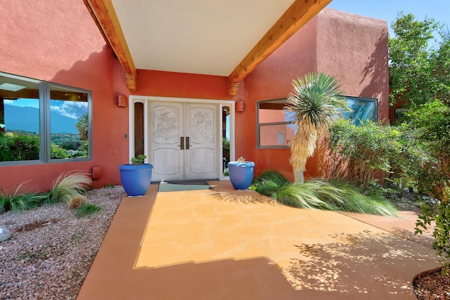 property entrance with stucco siding