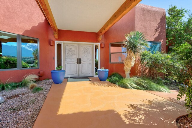 7 Calle Cholla, Placitas, NM 87043 - property entrance with stucco siding and french doors