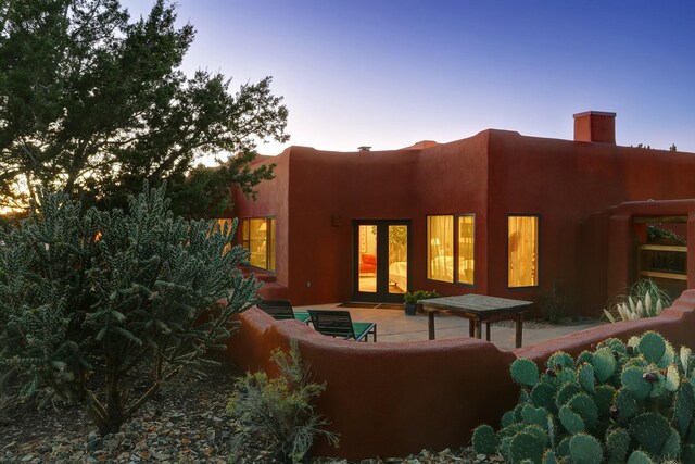 7 Calle Cholla, Placitas, NM 87043 - back of house featuring a chimney