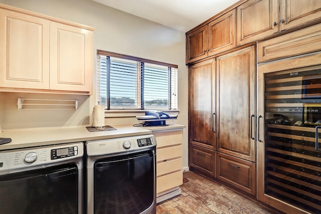 kitchen with brick floor, wine cooler, light countertops, and washer and clothes dryer