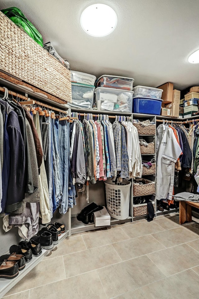 spacious closet featuring tile patterned flooring