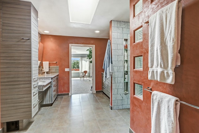 bathroom featuring recessed lighting, baseboards, vanity, and tile patterned flooring