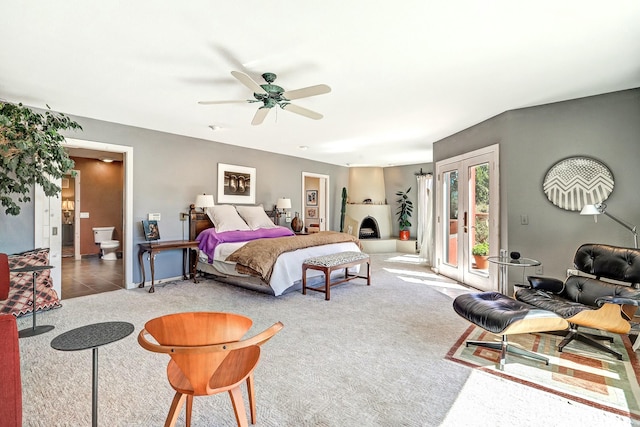 carpeted bedroom featuring ensuite bath, access to exterior, a ceiling fan, and tile patterned floors