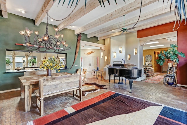 dining room featuring beam ceiling, ceiling fan with notable chandelier, brick floor, and baseboards