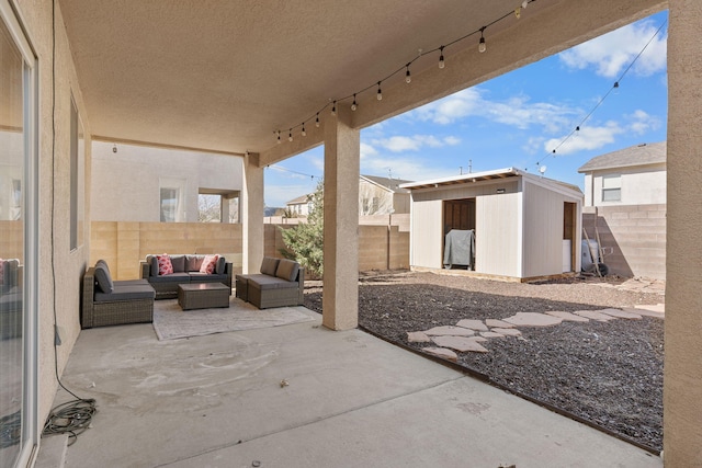 view of patio featuring a storage shed, a fenced backyard, outdoor lounge area, and an outbuilding