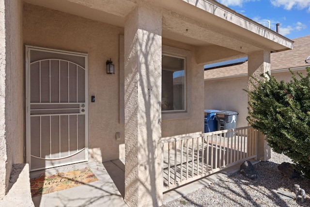 entrance to property with stucco siding