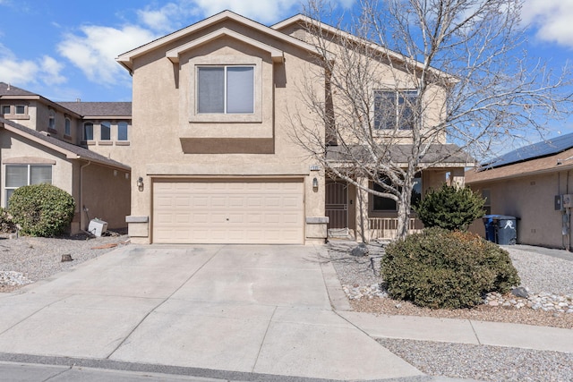 view of front of home featuring a garage, concrete driveway, and stucco siding