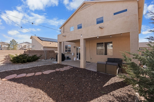 back of house featuring an outdoor living space, a patio, fence, and stucco siding