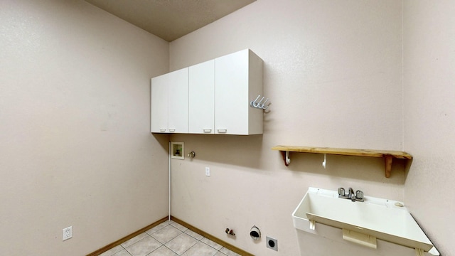 laundry room with gas dryer hookup, light tile patterned flooring, hookup for an electric dryer, washer hookup, and cabinet space