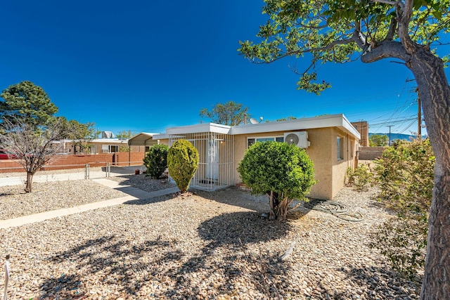 view of front of home featuring a gate, fence, and stucco siding