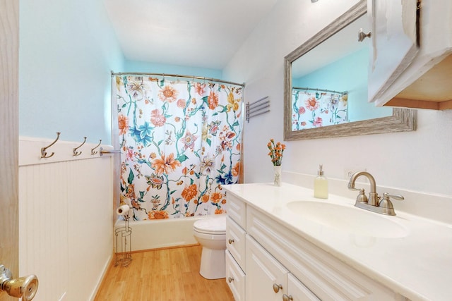 bathroom with shower / bath combo, vanity, toilet, and wood finished floors