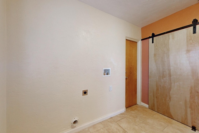 laundry room featuring a barn door, light tile patterned flooring, laundry area, washer hookup, and electric dryer hookup