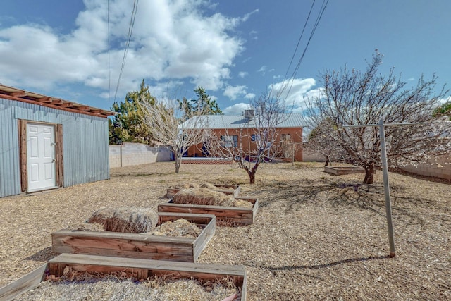 view of yard with a vegetable garden and fence