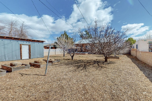 view of yard featuring fence and a garden