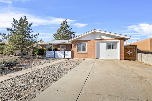 ranch-style home featuring fence and brick siding