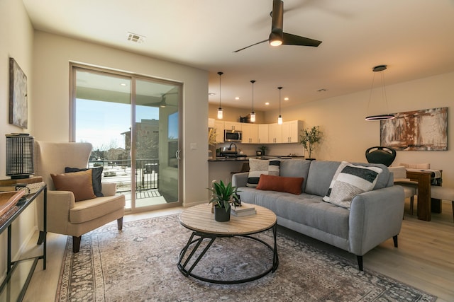 living room featuring recessed lighting, visible vents, ceiling fan, and light wood finished floors