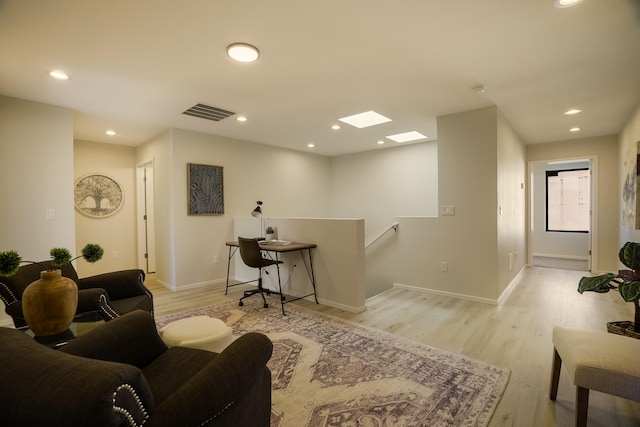 living room featuring a skylight, wood finished floors, visible vents, and recessed lighting