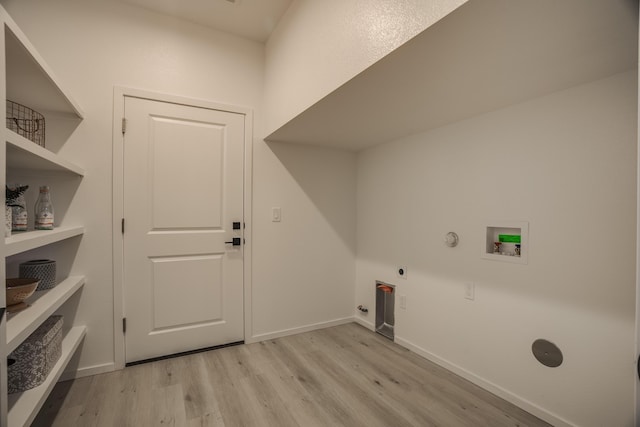 washroom with light wood finished floors, hookup for a washing machine, hookup for a gas dryer, electric dryer hookup, and laundry area