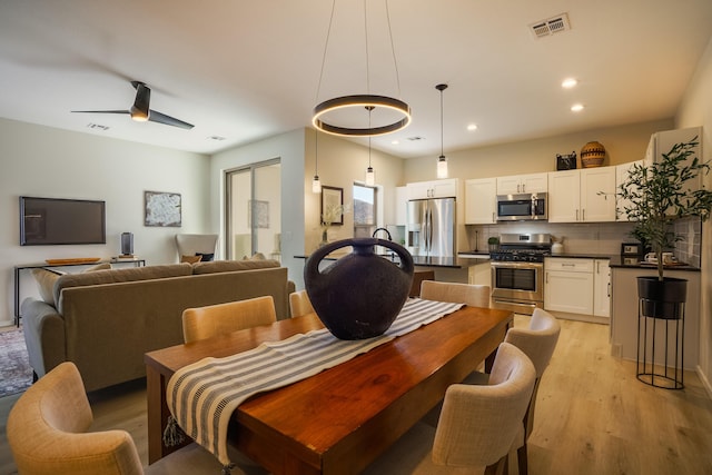 dining room with ceiling fan, light wood-style flooring, visible vents, and recessed lighting