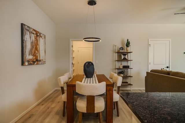 dining area with light wood-style flooring and baseboards