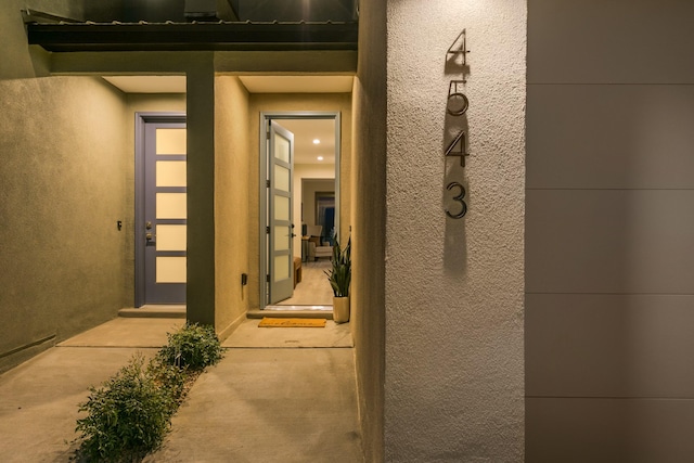 entrance to property with stucco siding