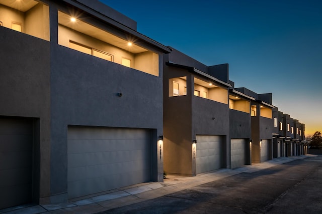 exterior space featuring a garage and stucco siding