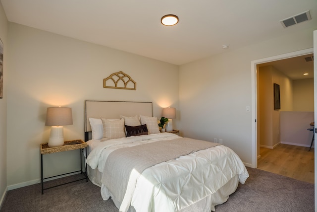 bedroom with baseboards, visible vents, and carpet flooring