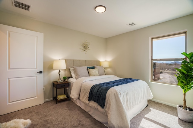 carpeted bedroom with visible vents and baseboards