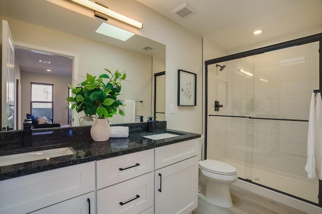 bathroom featuring ensuite bathroom, a sink, visible vents, a shower stall, and double vanity