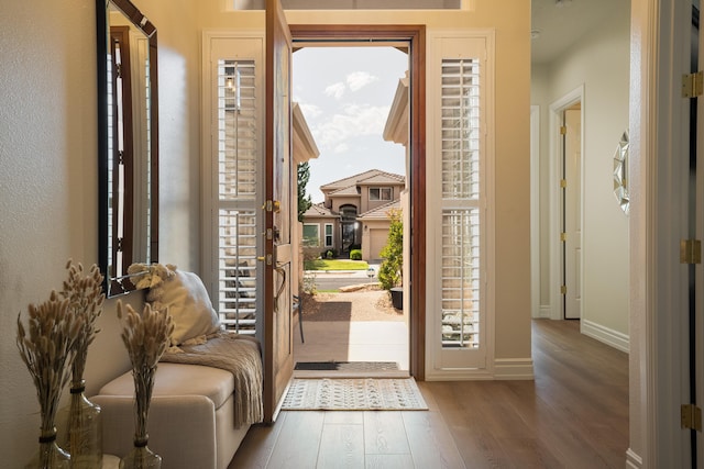 entrance foyer featuring baseboards and wood finished floors