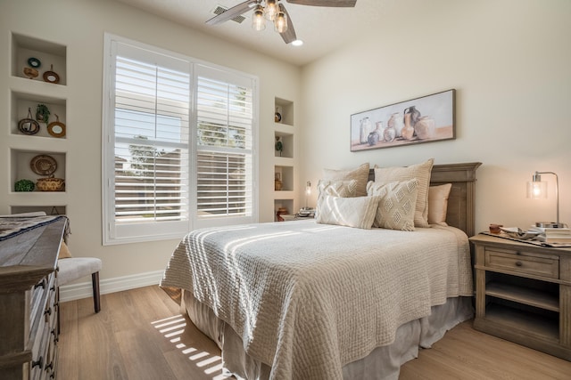 bedroom featuring baseboards, light wood-style floors, and a ceiling fan