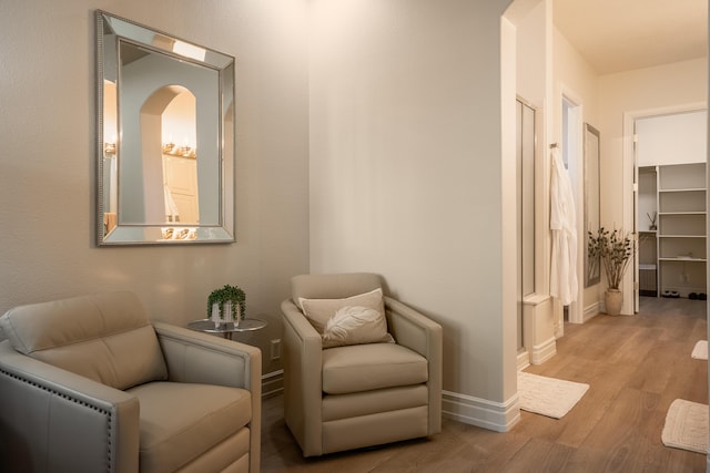 living area with light wood-type flooring and baseboards