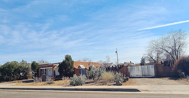 view of front of property featuring fence