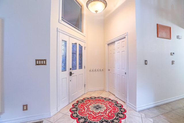 entrance foyer with baseboards and light tile patterned floors