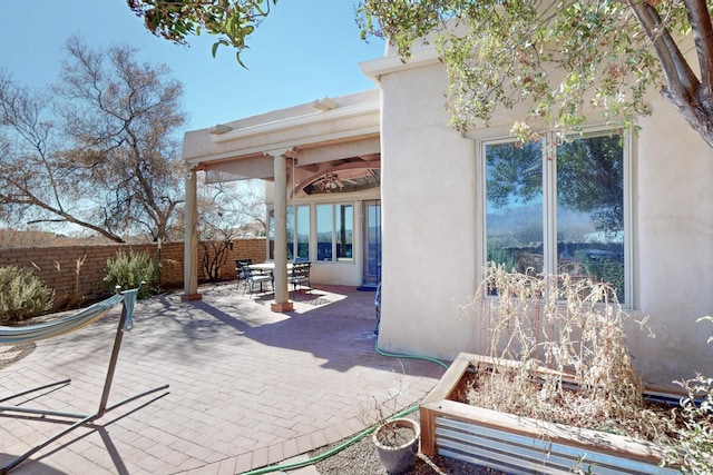 view of patio with outdoor dining space and fence