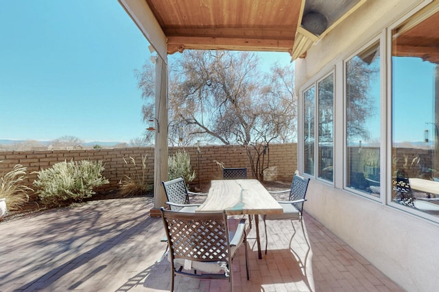 view of patio / terrace with outdoor dining space and fence