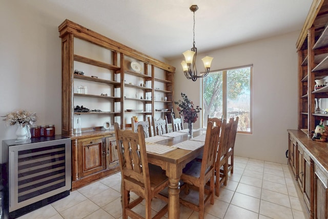 dining room featuring a notable chandelier, beverage cooler, and light tile patterned flooring