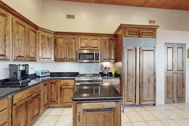 kitchen with light tile patterned floors, visible vents, brown cabinets, and appliances with stainless steel finishes