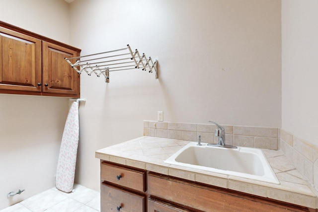 clothes washing area featuring a sink