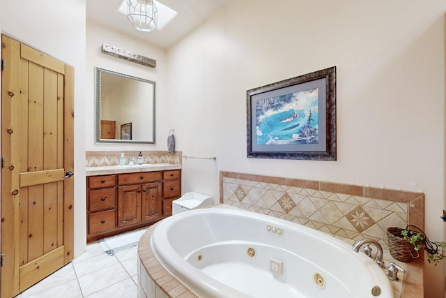 bathroom featuring tile patterned floors, vanity, and a whirlpool tub