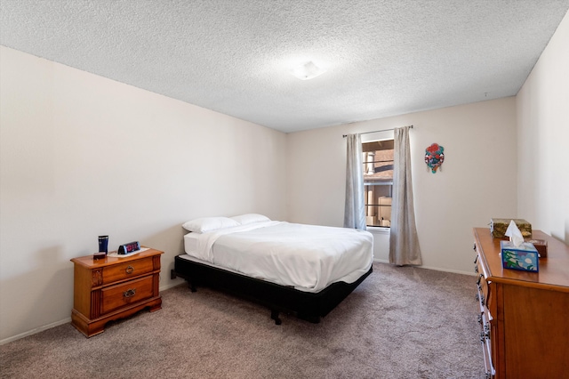 bedroom with light carpet, baseboards, and a textured ceiling